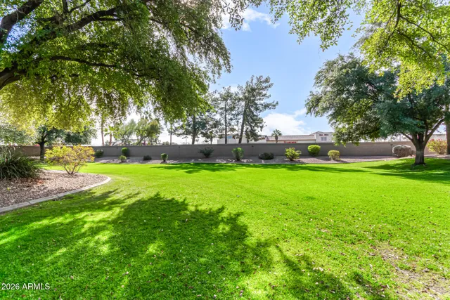 a view of a house with potted plants and a bench