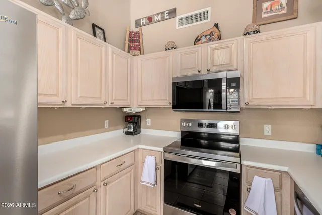 a kitchen with a sink stove and cabinets