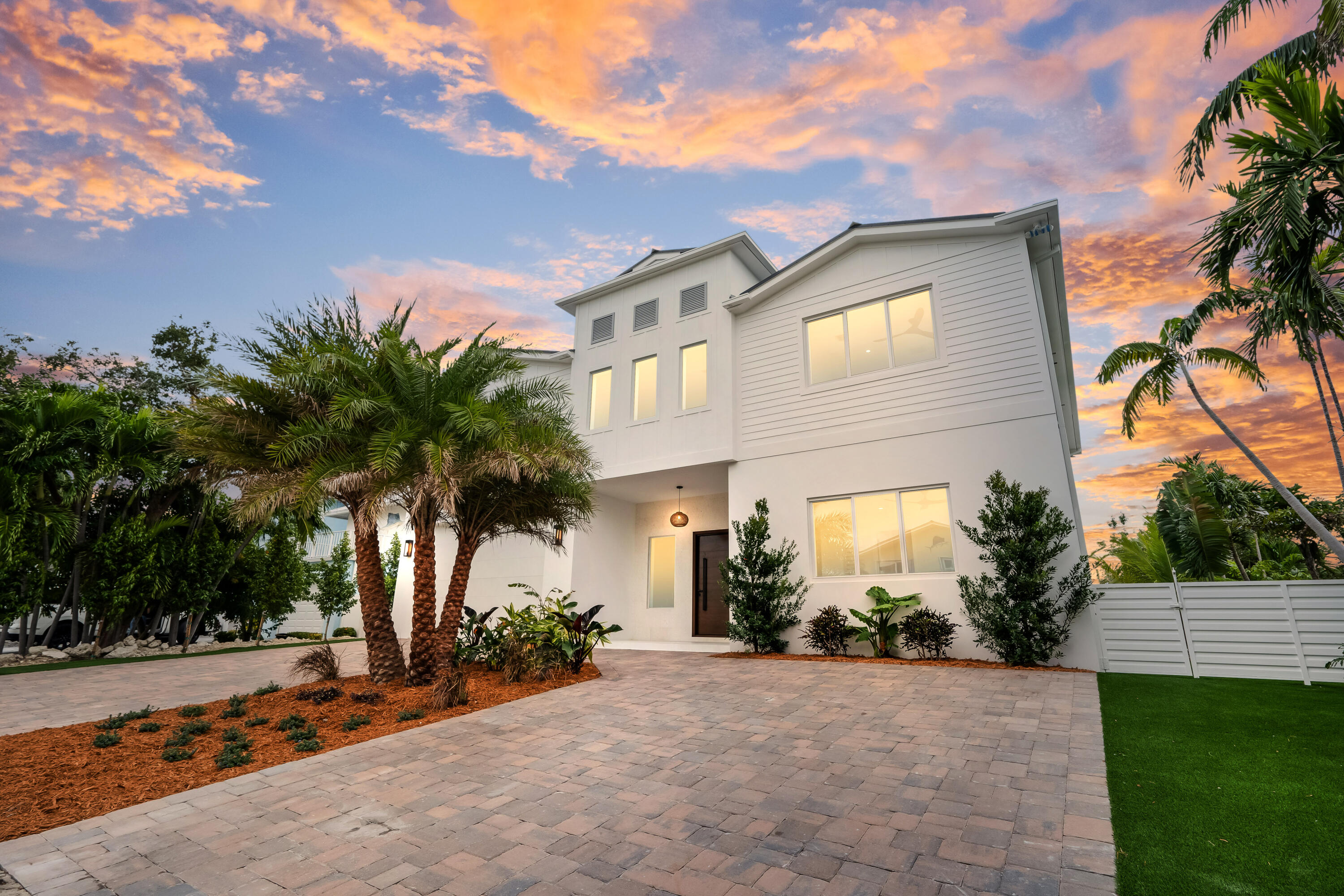 115 Spoonbill Road Tavernier, FL 33070 - Photo 1 of 85 a front view of a house with a yard and a garage