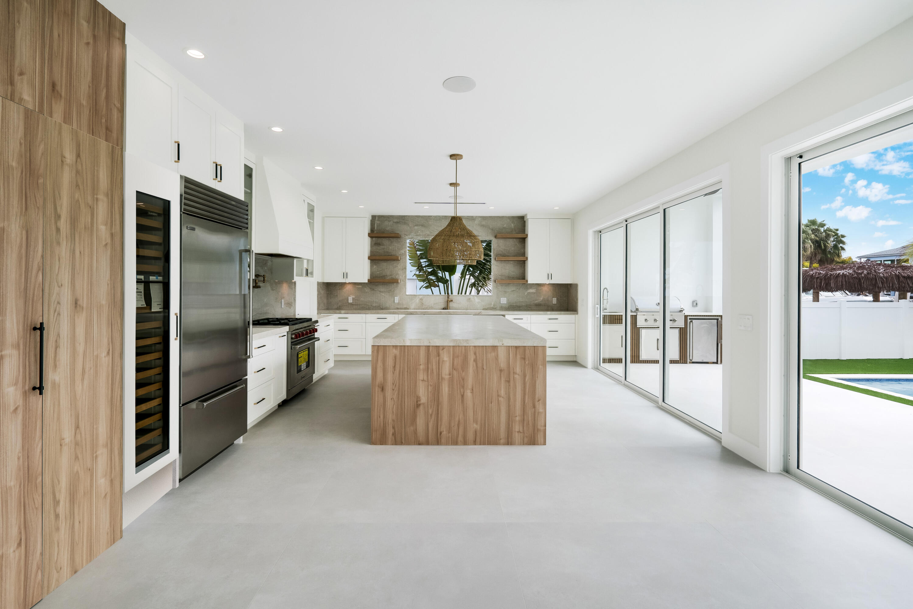 115 Spoonbill Road Tavernier, FL 33070 - Photo 14 of 85 a large kitchen with stainless steel appliances kitchen island granite countertop a refrigerator and a sink