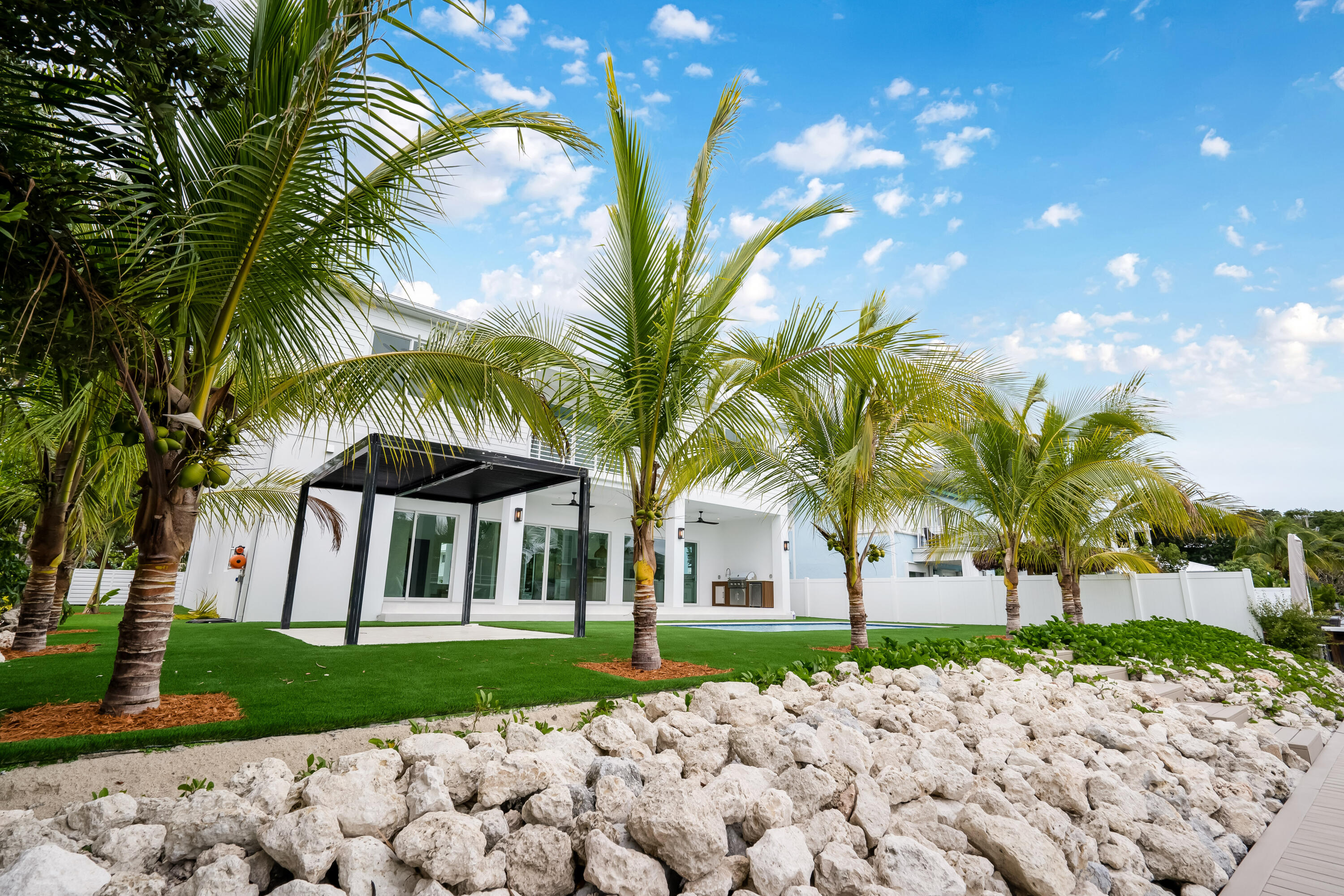115 Spoonbill Road Tavernier, FL 33070 - Photo 68 of 85 a view of a house with a yard and coconut trees