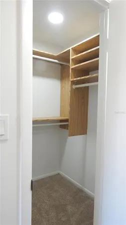 a view of room with white door and a cabinet