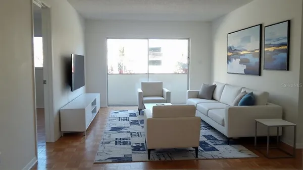 a living room with furniture and a flat screen tv