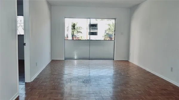 an empty room with window and mirror