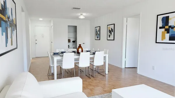 a dining room with furniture a rug and wooden floor