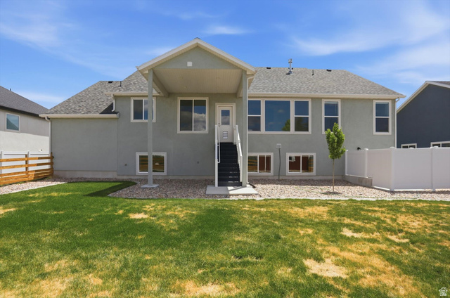 3636 West 910 South Syracuse, UT 84075 - Photo 61 of 70 Spacious backyard featuring a manicured lawn, gravel landscaping, and a covered patio