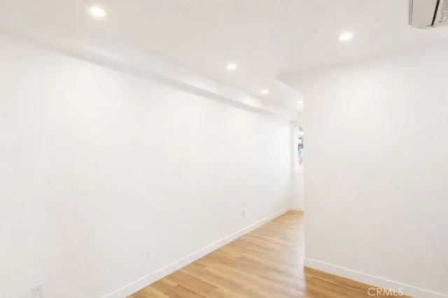 a view of hallway with wooden floor