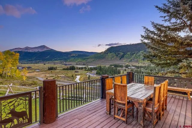 a view of a balcony with chairs and wooden floor