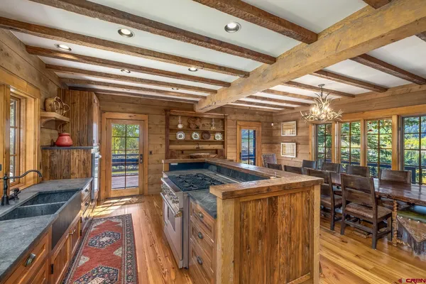 a kitchen with stainless steel appliances granite countertop a sink and wooden cabinets