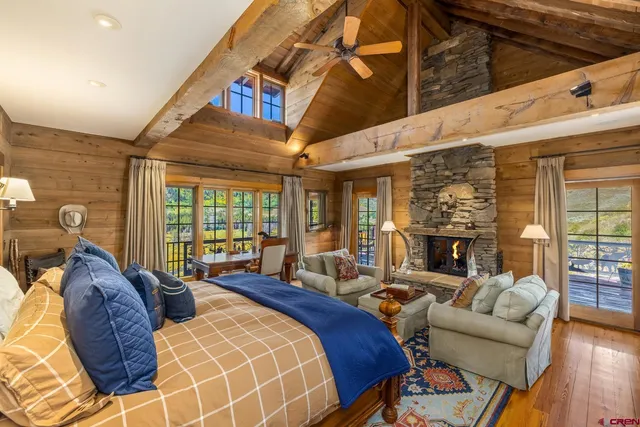 a living room with furniture a fireplace and wooden floor