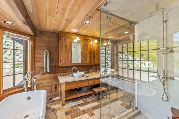 a very nice looking room with a large window and furniture