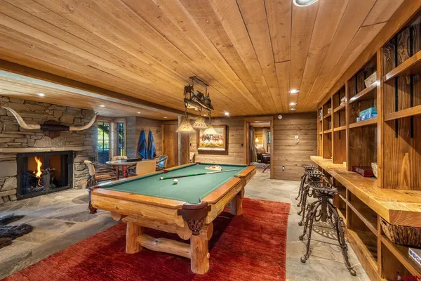 a room with pool table and windows