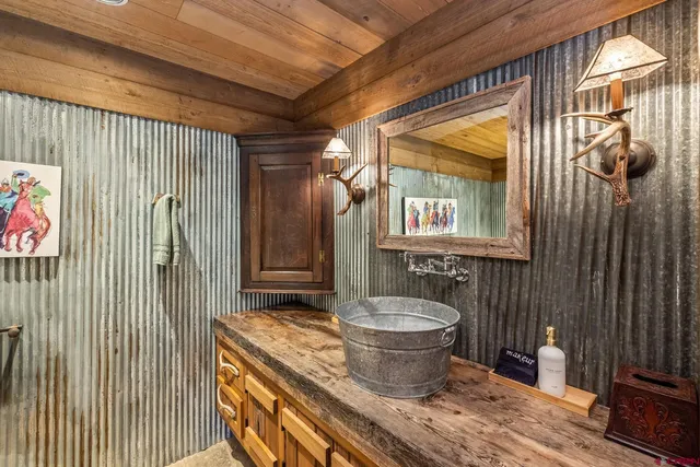 a bathroom with a granite countertop sink a toilet a mirror and shower
