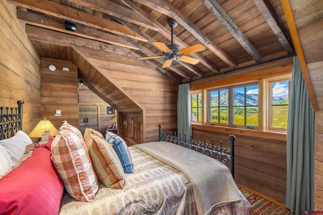 a bed sitting in a bedroom next to a window