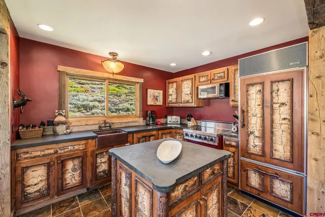 a kitchen with a stove a sink and a refrigerator