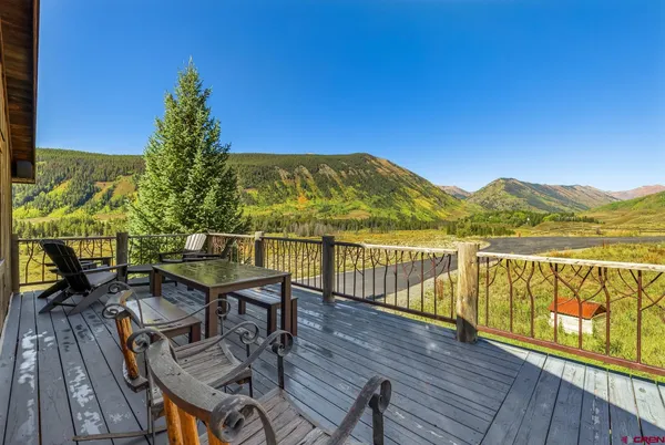 a view of a balcony with wooden floor and outdoor space