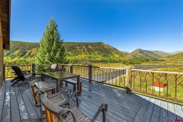 a view of a balcony with wooden floor and outdoor space