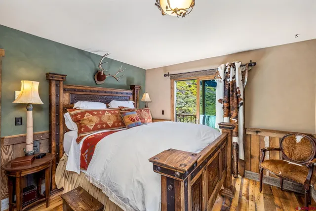 a bed sitting in a bedroom next to a window