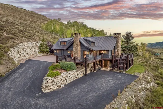 a view of a house with a yard and sitting area