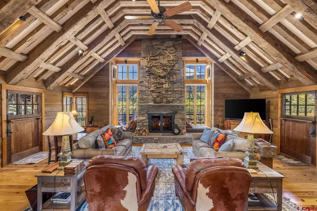 a living room with fireplace furniture and a large window