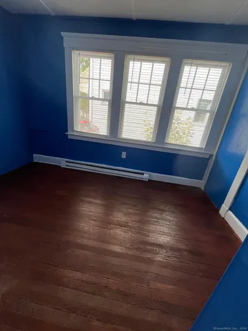 a view of room with window and wooden floor