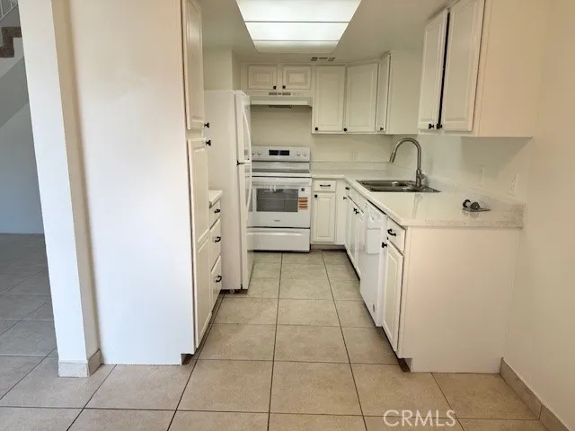 a kitchen with stainless steel appliances a sink and cabinets