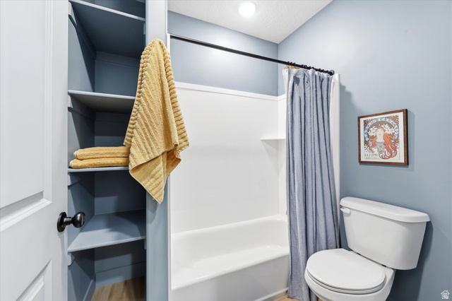 283 North 500 West Mapleton, UT 84664 - Photo 74 of 102 Bathroom featuring toilet and shower / bath combination with curtain.
