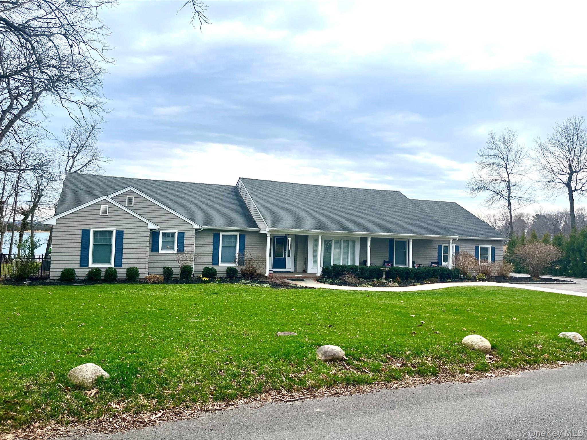 24 Bevin Road Northport, NY 11768 - Photo 1 of 3 a front view of a house with garden and trees