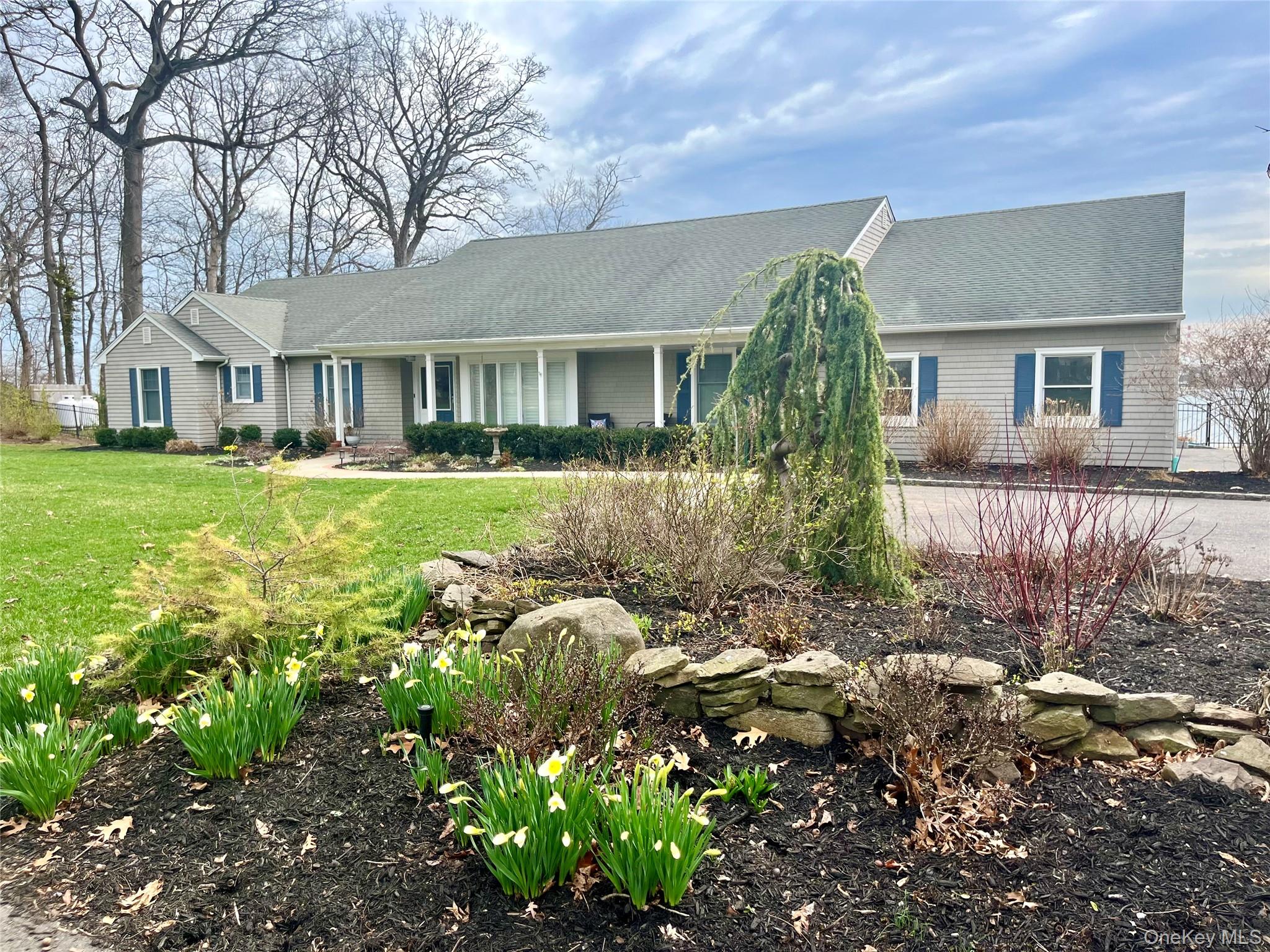 24 Bevin Road Northport, NY 11768 - Photo 2 of 3 front view of a house with a yard