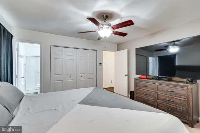 a bedroom with a large bed and a large mirror