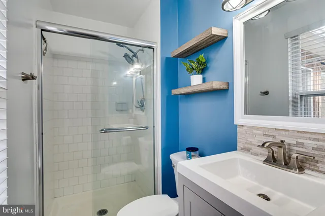 a bathroom with a sink toilet and shower