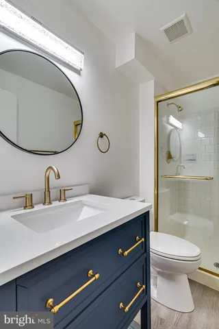 a bathroom with a toilet a sink and mirror
