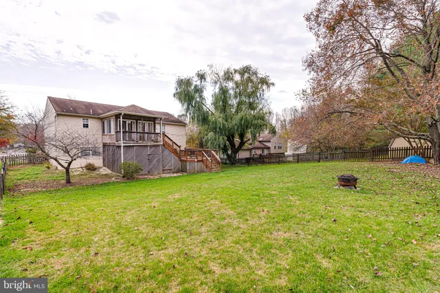 a view of a house with a yard and sitting area