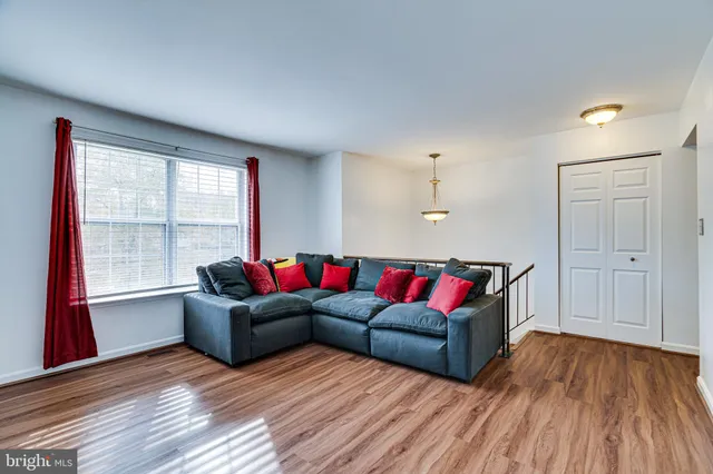 a living room with furniture window and wooden floor
