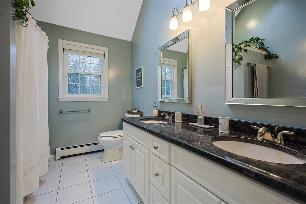 26 Reservoir Road Milford, MA 01757 - Photo 18 of 42 a bathroom with a granite countertop sink a toilet and a mirror