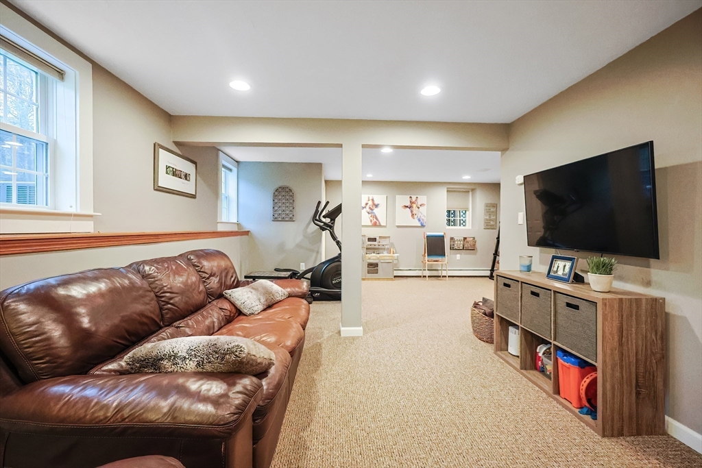 26 Reservoir Road Milford, MA 01757 - Photo 27 of 42 a living room with furniture and a flat screen tv