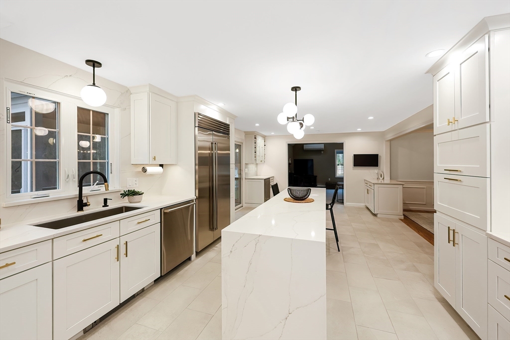 26 Reservoir Road Milford, MA 01757 - Photo 5 of 42 a large white kitchen with cabinets and stainless steel appliances