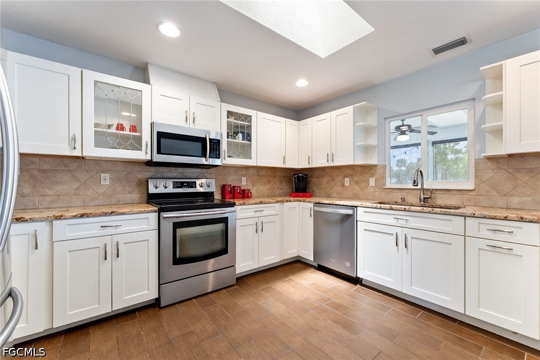 17290 Rewis Road Alva, FL 33920 - Photo 11 of 50 a kitchen with sink a microwave and cabinets