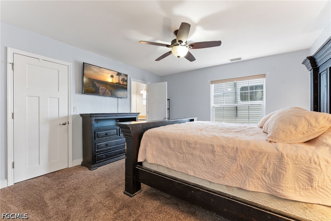 17290 Rewis Road Alva, FL 33920 - Photo 14 of 50 a bedroom with a bed and a flat screen tv