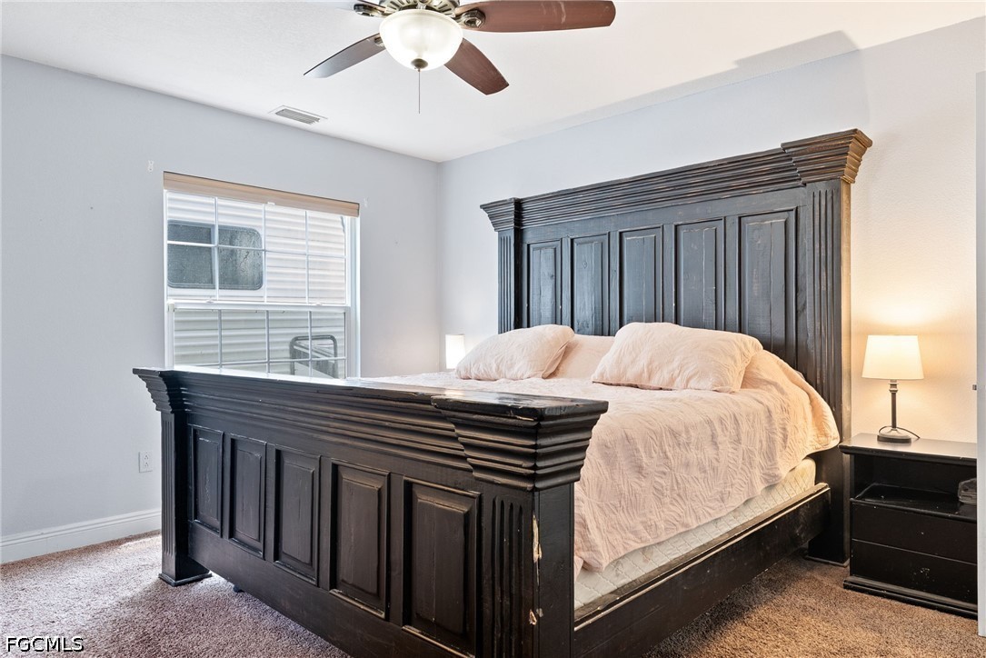 17290 Rewis Road Alva, FL 33920 - Photo 15 of 50 a bedroom with a bed and wooden floor