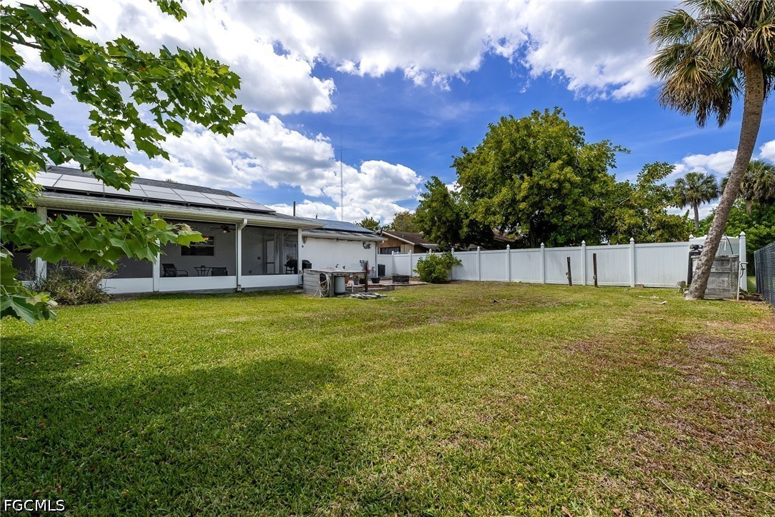 17290 Rewis Road Alva, FL 33920 - Photo 30 of 50 a view of a house with a backyard and a tree