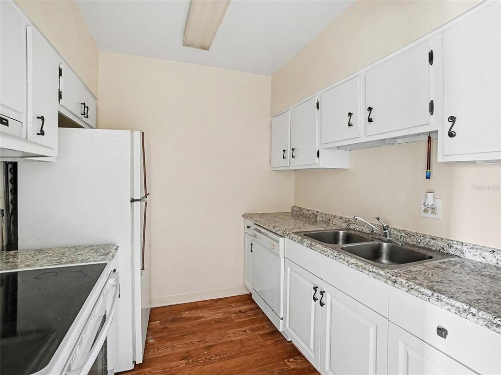 2500 Lee Road, Unit 237 Winter Park, FL 32789 - Photo 10 of 23 a kitchen with stainless steel appliances granite countertop a sink stove and refrigerator