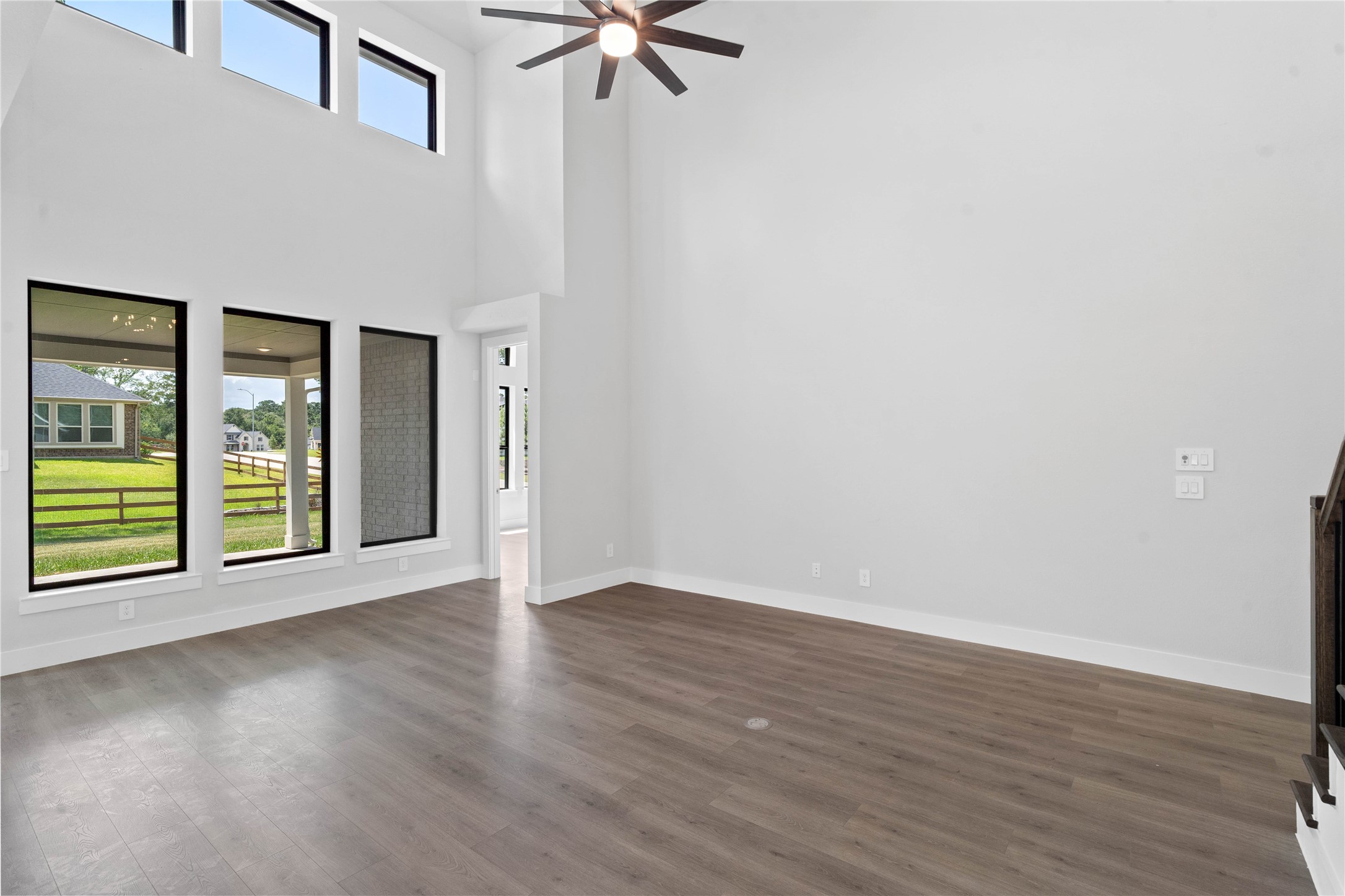 551 Black Bronco Road Magnolia, TX 77354 - Photo 14 of 50 A grand great room with tall ceilings, ceiling fan, abundant natural light, and an open, inviting ambiance--perfect for gatherings, relaxation, and making memories.