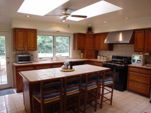 741 Braeburn Road Inverness, IL 60067 - Photo 4 of 10 a kitchen with a stove a sink a dining table and chairs