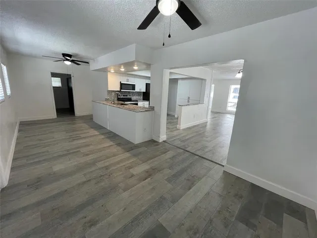 a large kitchen with cabinets and stainless steel appliances
