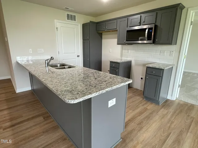a kitchen with a sink and microwave