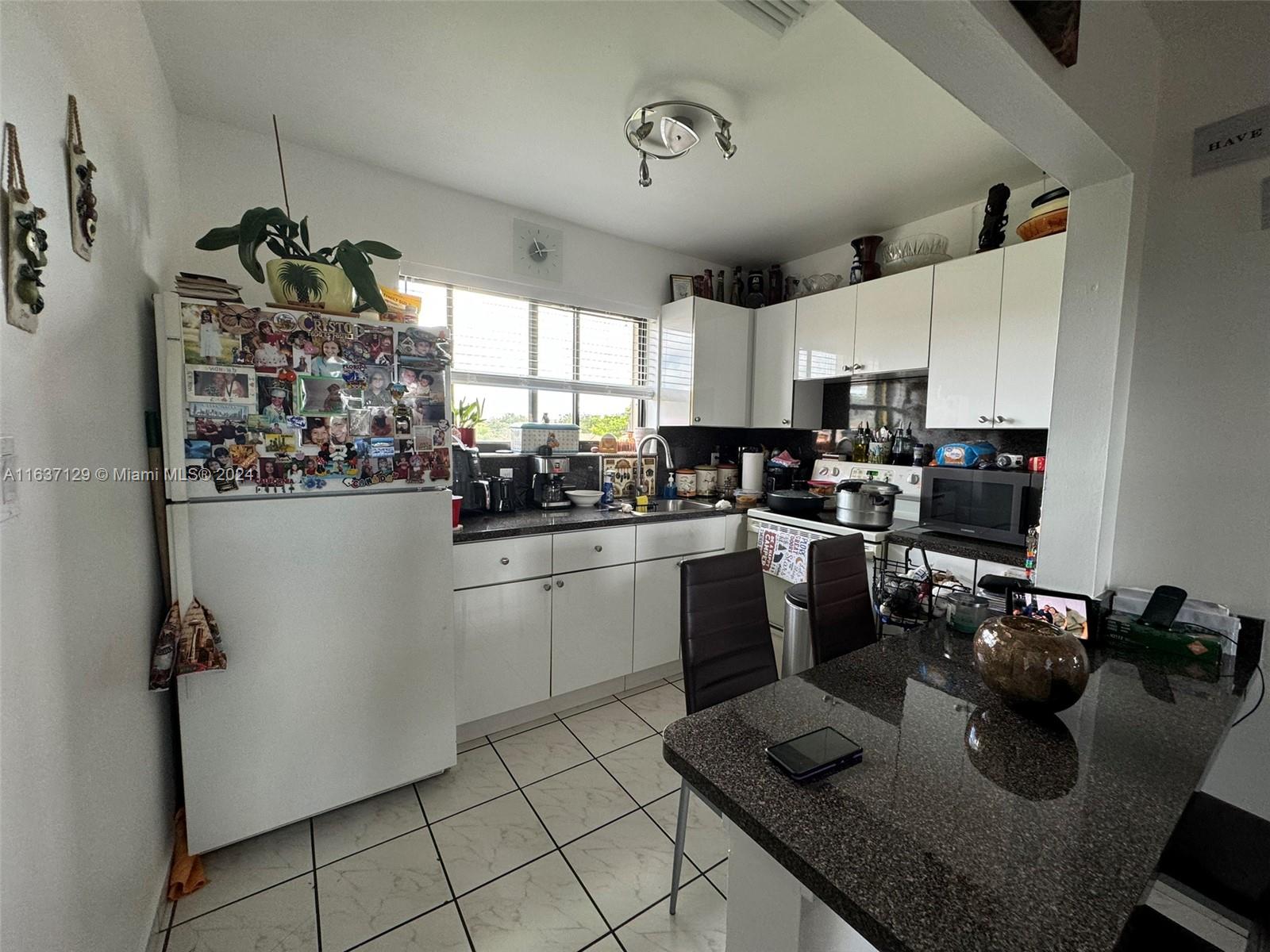 231 East 7th Street Hialeah, FL 33010 - Photo 15 of 39 a kitchen with a sink appliances and cabinets