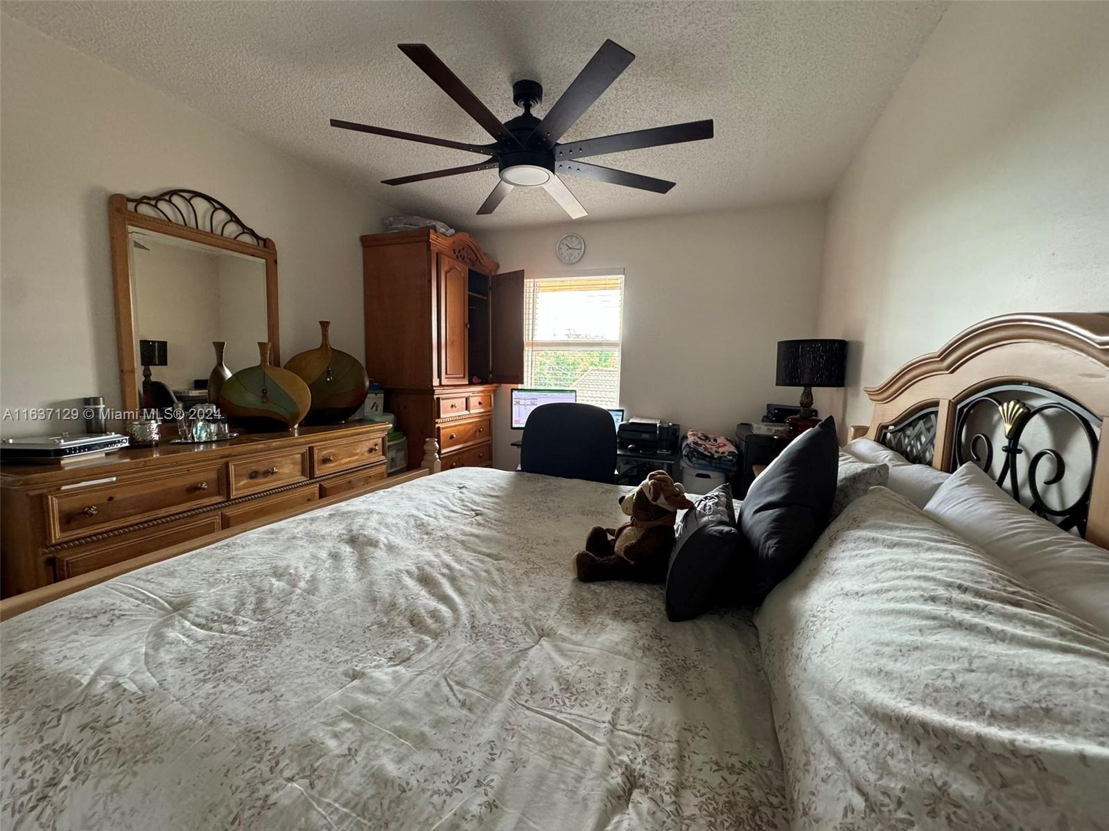 231 East 7th Street Hialeah, FL 33010 - Photo 23 of 39 a living room with furniture ceiling fan and a large window