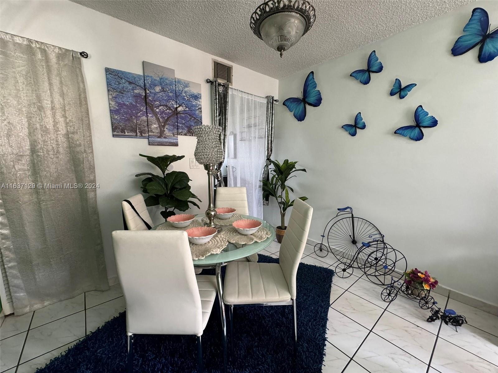 231 East 7th Street Hialeah, FL 33010 - Photo 27 of 39 a view of a dining room with furniture and wooden floor