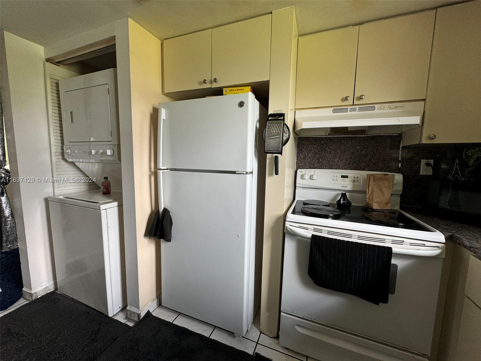 231 East 7th Street Hialeah, FL 33010 - Photo 31 of 39 a white refrigerator freezer and a stove sitting inside of a kitchen